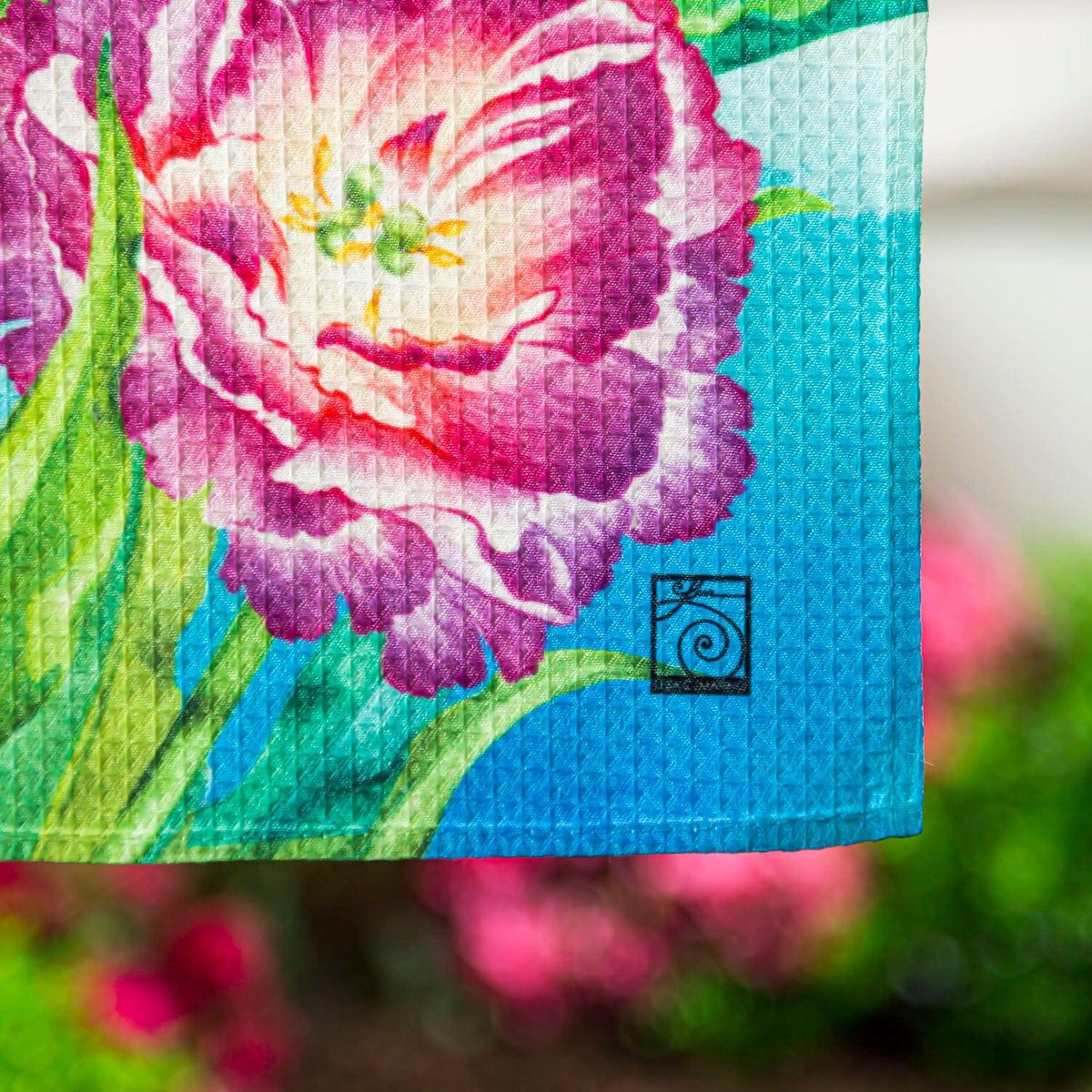 The Blooming Tulips garden flag features blue butterflies among vividly colored tulips in full bloom.