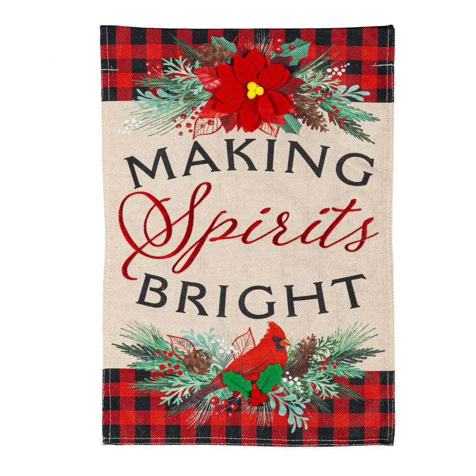 The Christmas Joy garden flag features a poinsettia, a cardinal, a black and red checked border, and the words "Making Spirits Bright".