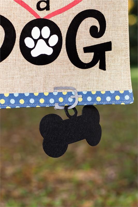 Life is Better With a Dog garden flag features heart, paw print, and dangling dog bone.