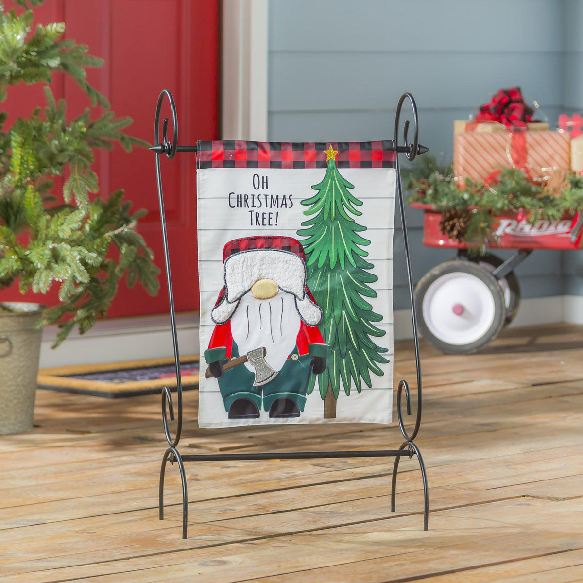 The Lumberjack Gnome garden flag features a pine tree with a lumberjack-dressed gnome holding an ax and the words "Oh Christmas Tree".