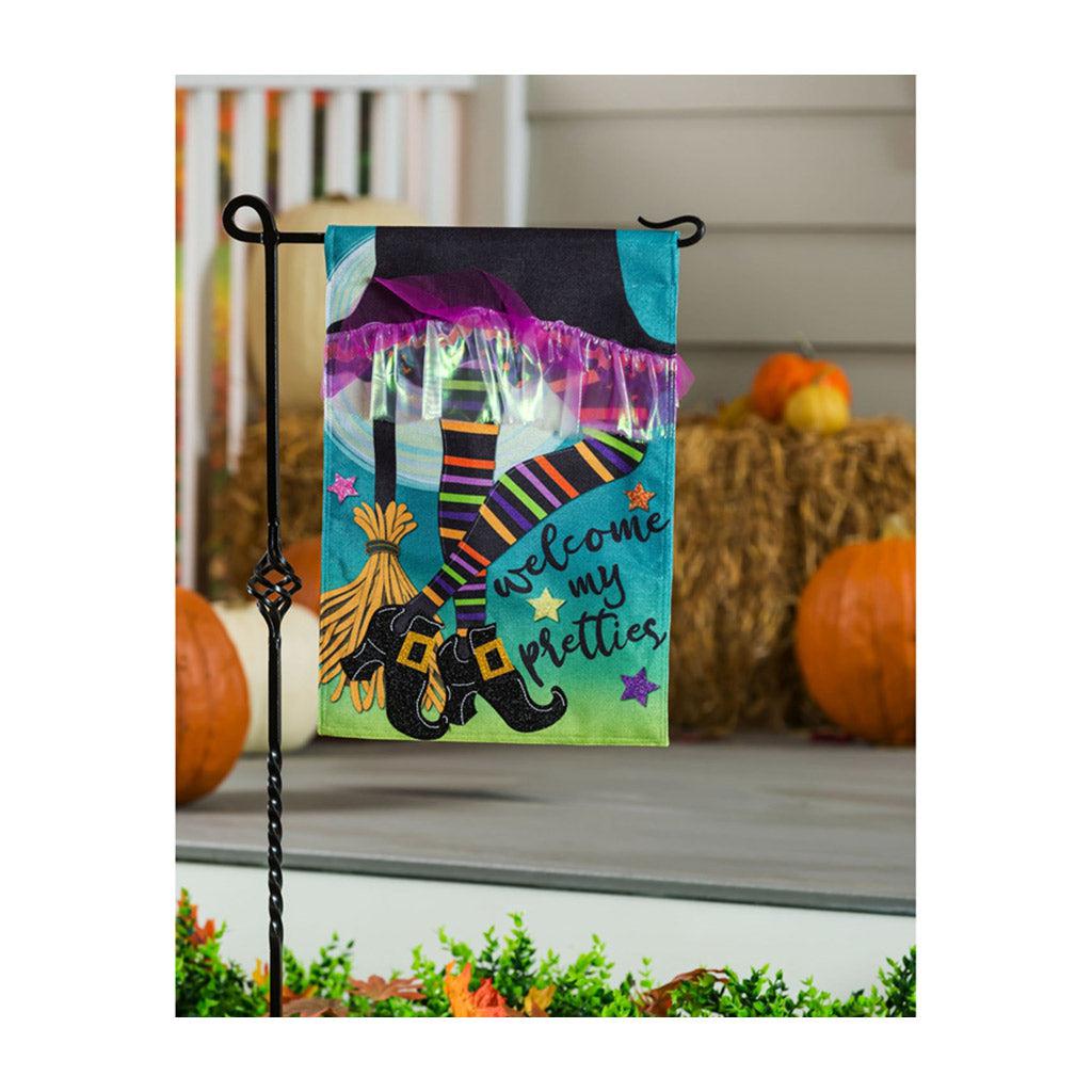 The My Pretties garden flag features a witch's skirt, striped legs and broom and the words "Welcome My Pretties". 