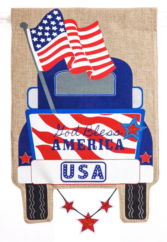 The Patriotic Pick-Up Truck garden flag features a blue truck flying a U.S. flag with a U.S.A. license plate and the words "God Bless America" across the striped tailgate.