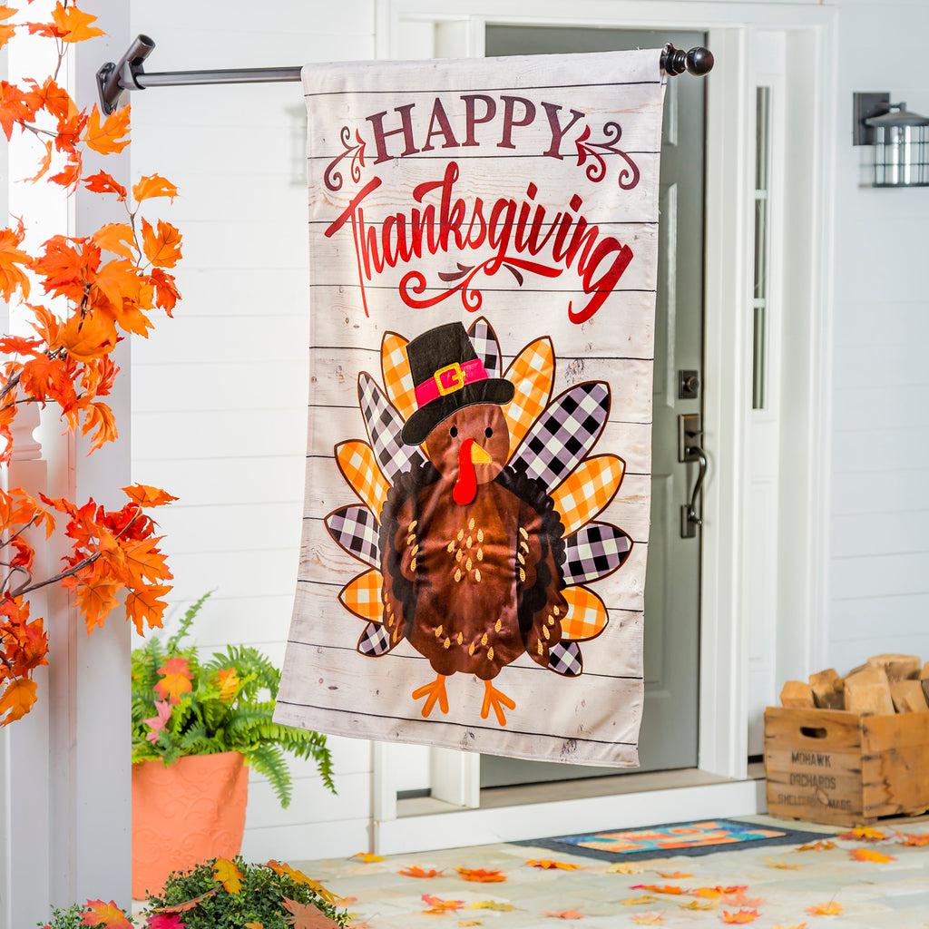 The Pilgrim Turkey house banner features a turkey with a pilgrim hat, alternating gold and black checked tail feathers, and the words "Happy Thanksgiving". 