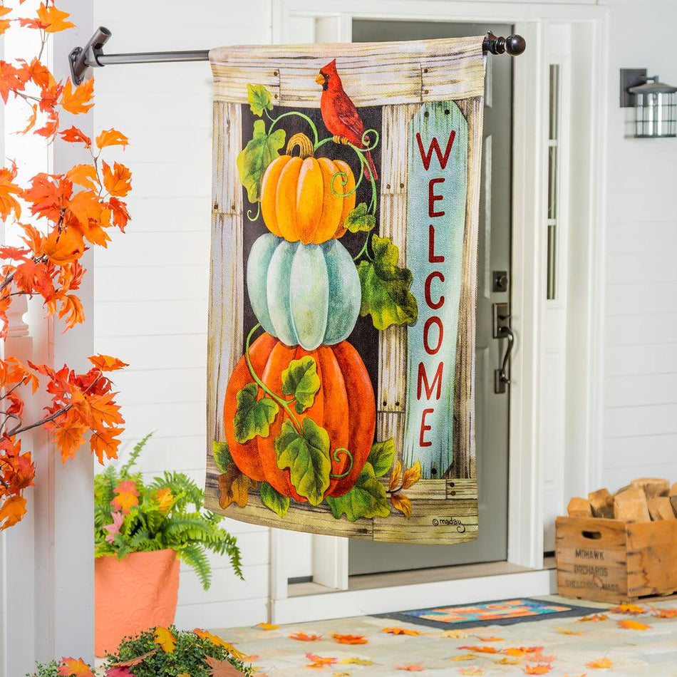 The Pumpkin Stack house banner features a stacked trio of different colored pumpkins with a bright red cardinal sitting on top, and the word "Welcome" down the side.