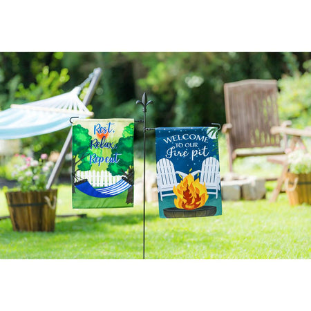 The Rest, Relax, Repeat Hammock garden flag features a blue and white striped hammock strung between two trees and the words "Rest, Relax, Repeat". 