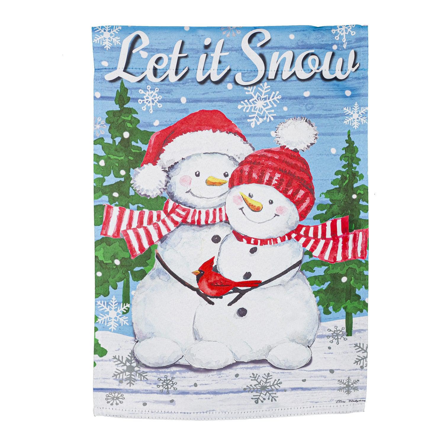 The Snowman Family garden flag features a smiling snow couple with red hats and scarves holding a cardinal along with the words "Let it Snow".