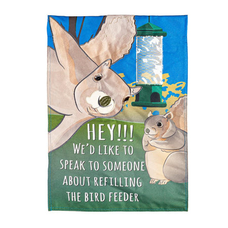 Our Squirrel Feeder garden flag features two squirrels appearing to look at you, an empty bird feeder, and the words "HEY!!! We'd like to speak to someone about refilling the bird feeder". 