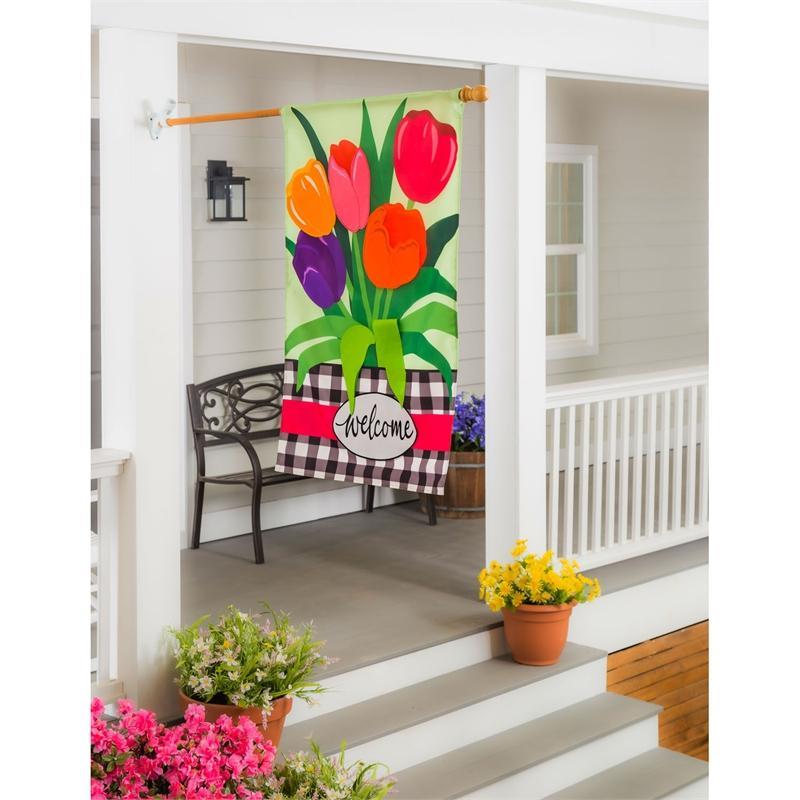 The Welcome Spring Tulips house banner features brightly colored appliquéd tulips on a spring green background and the word "Welcome" on a black and white checked bottom border. 