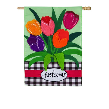 The Welcome Spring Tulips house banner features brightly colored appliquéd tulips on a spring green background and the word "Welcome" on a black and white checked bottom border. 